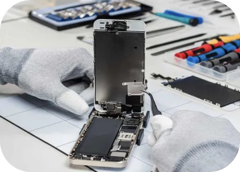 A technician in gloves taking apart an iPhone screen